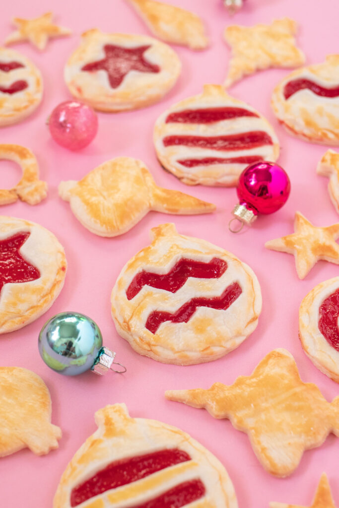 Ornament Pies // Christmas Hand Pies // Cut pie dough into ornament shapes with cut-out details for making cute mini Christmas pies! Fill with colorful cherry pie filling for a great holiday treat or after-dinner Christmas dessert #christmasrecipe #pie #handpies #christmasdessert #pierecipe #cookiecutters #diyornaments