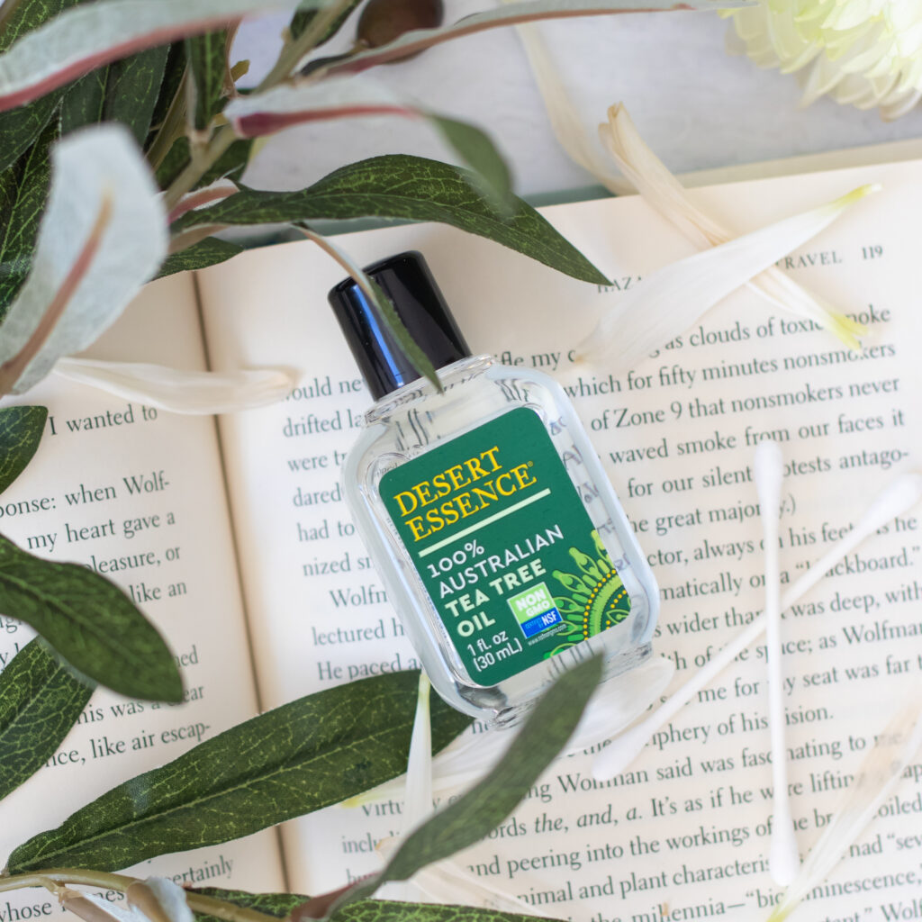 oil bottle on book with greenery for product photography